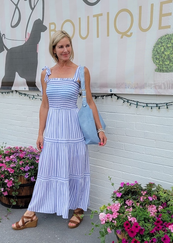 Lady wearing a blue striped dress.