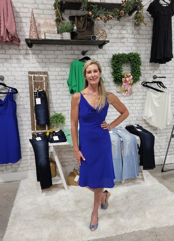 Lady wearing a royal blue cocktail dress.